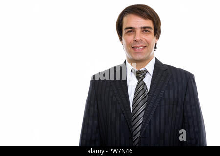 Studio shot of young happy Persian businessman smiling Stock Photo