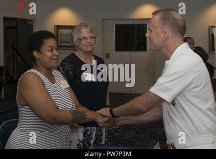 WASHINGTON (Sept. 24 2017) Master Chief Petty Officer of the Navy, Steven Giordano, shakes hands with a Gold Star family member at the Gold Star Mother's and Family Day observance at Joint Base Anacostia-Bolling. MCPON served as a guest speaker during the event, which honored and recognized the sacrifices of Gold Star families. Stock Photo