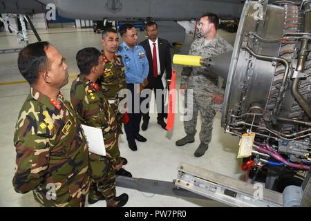 Oregon Air National Guard Staff Sgt. Mike Mitchell, 142nd Fighter Wing Maintenance Group (right) discusses the engines used in the F-15 Eagle to members of the Bangladesh military touring the base as part of the State Partnership Program between Oregon and Bangladesh, Sept. 27, 2017. Stock Photo