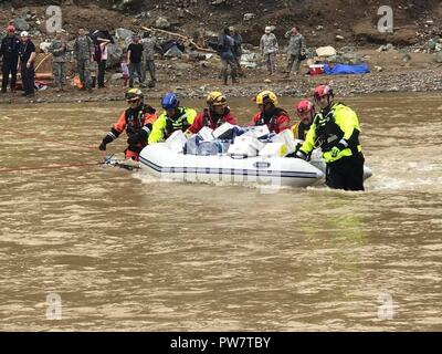 UTUADO, Puerto Rico, Sept. 26, 2017 - Members of New York Task Force 1 and the Puerto Rico National guard delivered food and water to residents near Utuado, Puerto Rico, Sept. 26. Stock Photo