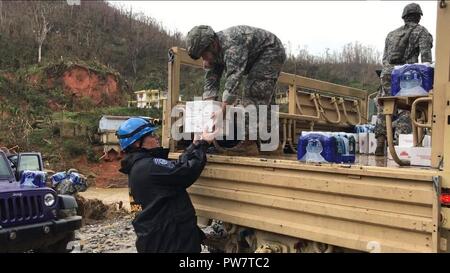 UTUADO, Puerto Rico, Sept. 26, 2017 - Members of New York Task Force 1 and the Puerto Rico National guard delivered food and water to residents near Utuado, Puerto Rico, Sept. 26. Stock Photo