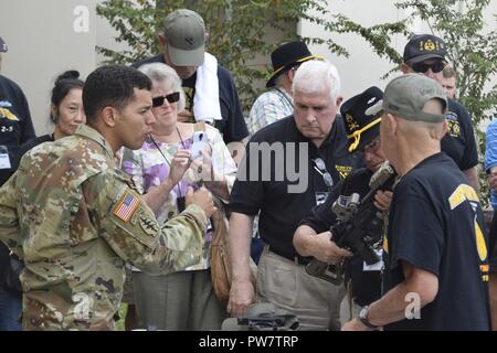 Vietnam veterans of Company Echo, 2nd Battalion, 5th Cavalry, 1st Cavalry Division (RECONNAISSANCE) tour modern weapons systems and visit with Special Forces Soldiers during a welcome of the vets and their families to the 7th Special Forces Group (Airborne) compound, Sept. 26, 2017. Stock Photo