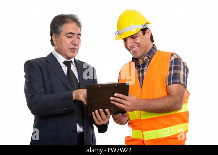 Happy senior Persian businessman and young Persian man construct Stock Photo