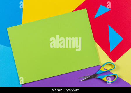 Top view of colored paper with colorful scissors. Kids art and craft paper applique background Stock Photo