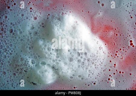 White foam with bubbles on the red background Stock Photo