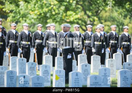 The U.S. Navy Ceremonial Guard and U.S. Navy Band participate in the graveside service for U.S. Navy Fireman 1st Class Walter B. Rogers at Arlington National Cemetery, Arlington, Va., Oct. 2, 2017.  Rogers perished on the USS Oklahoma when it was attacked by Japanese aircraft at Ford Island, Pearl Harbor on Dec. 7, 1941.  Remains of the deceased crew were recovered from December 1941 to June 1944 and were subsequently interred in the Halawa and Nu’uanu Cemeteries.  In September 1947, the remains were disinterred and 35 men from the USS Oklahoma were identified by the American Graves Registrati Stock Photo