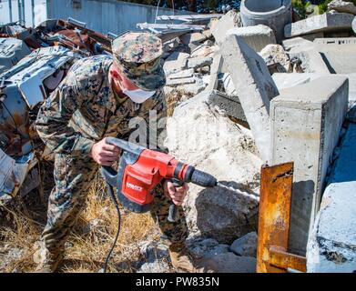 SAN FRANCISCO (Oct. 3, 2017) Pfc. Tanner Thawley, attached to Combat Logistics Battalion 11, uses a hammer drill for urban search and rescue training during Fleet Week San Francisco 2017. Fleet week provides an opportunity for the American public to meet their Navy, Marine Corps, and Coast Guard team and to experience America’s sea service. Fleet Week San Francisco will highlight naval personnel, equipment, technology, and capabilities, with an emphasis on humanitarian assistance and disaster response. Stock Photo