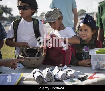 Young Airmen check in at the Operation Hero processing line Sept. 30 at Eglin Air Force Base, Fla. More than 470 kids participated in the event set up to show the process their parents go through before they leave home. They participated in three phases. The first included a deployment line for dog tag issue and “immunizations.” After a brief from the commander they moved on to Phase Two activities set up by base organizations. The last phase included a welcome home lunch. Stock Photo