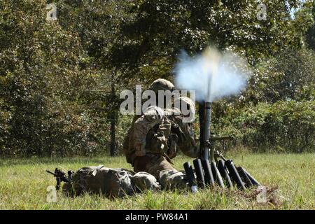 Pfc. Zachary Ledesma, of Austin, Tx., and Spc. Tyreese McNeese, of Compton, Calif., both mortar men assigned to Company C “Cold Steel”, 1st Battalion, 327th Infantry Regiment, fire a 60mm. mortar toward simulated enemy positions, Sept. 28, 2017, at Fort Campbell, Ky. Co. C, 1-327 Inf. Regt., conducted a company-level combined arms live-fire exercise to culminate several weeks of team, squad, platoon, and company training. Stock Photo