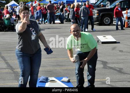 YOUNGSTOWN STATE UNIVERSITY, Ohio – Air Force Reserve 910th Airlift Wing Director of Psychological Health Terri Ann Naughton, shows off her skills as Staff Sgt. Nicholas Bacisin, a military personnel technician assigned to the 910th Force Support Squadron, reacts during a cornhole match at a 910th Airlift Wing tailgate picnic here, Sept. 30, 2017. Approximately 50 football fans representing the wing’s Citizen Airmen, along with their coworkers, families and friends enjoyed a tailgate picnic on a cool but sunny fall afternoon. After tailgating festivities, the 910th group, based at nearby Young Stock Photo