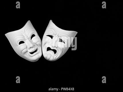 theatre mask expresing the tragedy and the comedy, white mask on black background with free space for text Stock Photo