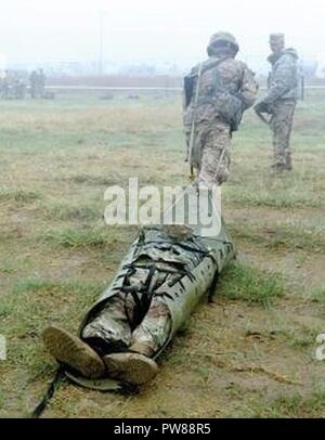 An Expert Infantryman Badge candidate transports a casualty during a nine-line medical evacuation training lane. Stock Photo