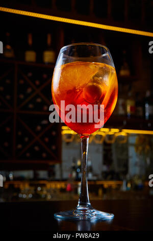 Aperol Spritz Cocktail Alcoholic beverage based on bar counter with ice cubes and oranges Stock Photo