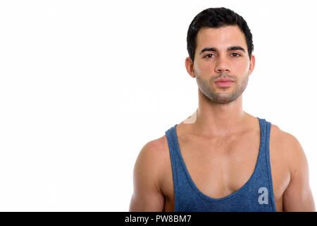 Studio shot of young handsome Hispanic man Stock Photo