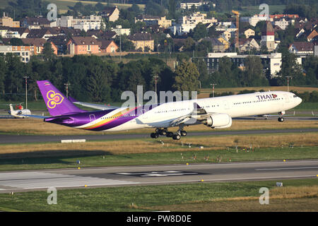 Thai Airways International Airbus A340-600 with registration HS-TNC on short final for runway 34 of Zurich Airport. Stock Photo