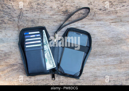 Leather phone case in shape of Coffin on the wooden backgrounde Stock Photo