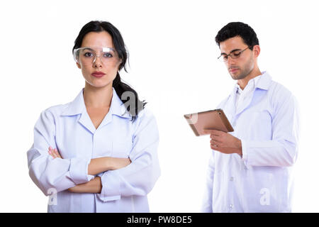 Young woman doctor wearing protective glasses with arms crossed  Stock Photo