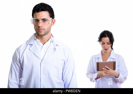 Studio shot of young man doctor wearing protective glasses and w Stock Photo
