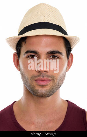 Face of young handsome Hispanic man wearing hat Stock Photo