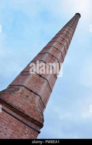 Low angle shot of old octogonal industrial brick chimney at San Lorenzo,  Segovia, Spain Stock Photo