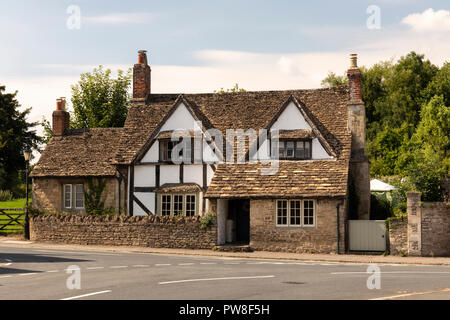 A traditional limewashed half timbered house in the village of Lacock, Wiltshire, England, UK
