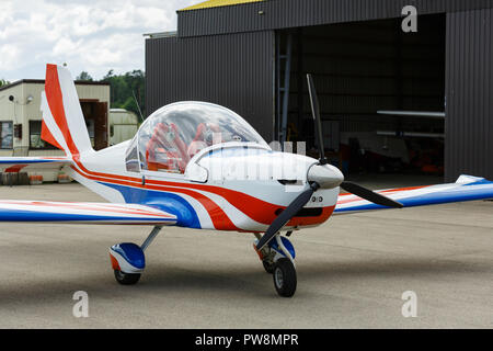 outdoor shot of small plane standing in shed Stock Photo