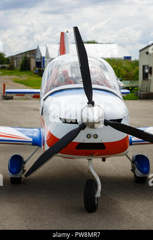 outdoor shot of small plane standing in shed Stock Photo