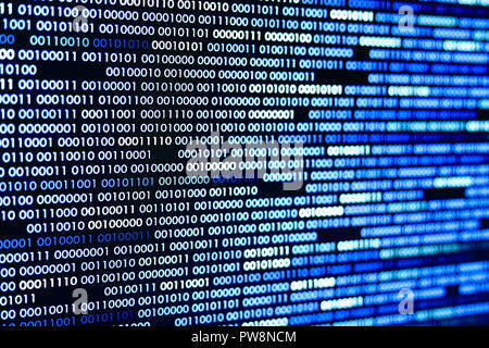 Big overload blockchain data. Blue binary data code background for internet and cyberspace security function. one and zero text on LED moniter screen. Stock Photo