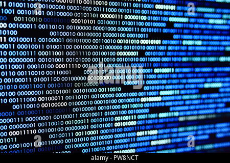 Big overload blockchain data. Blue binary data code background for internet and cyberspace security function. one and zero text on LED moniter screen. Stock Photo