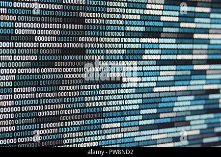 Big overload blockchain data. Blue binary data code background for internet and cyberspace security function. one and zero text on LED moniter screen. Stock Photo