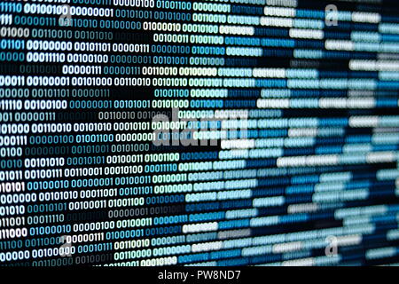 Big overload blockchain data. Blue binary data code background for internet and cyberspace security function. one and zero text on LED moniter screen. Stock Photo