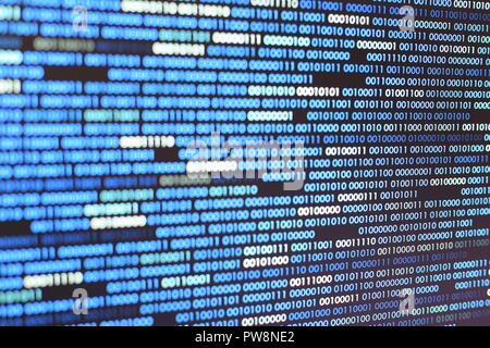 Big overload blockchain data. Blue binary data code background for internet and cyberspace security function. one and zero text on LED moniter screen. Stock Photo