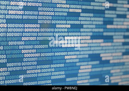 Big overload blockchain data. Blue binary data code background for internet and cyberspace security function. one and zero text on LED moniter screen. Stock Photo