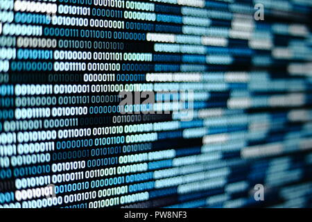 Big overload blockchain data. Blue binary data code background for internet and cyberspace security function. one and zero text on LED moniter screen. Stock Photo