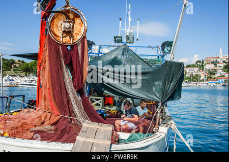 8. 28. 2012. Vrsar. Croatia. Two sailors clean the fish caught. Fishing in the Adriatic sea Stock Photo