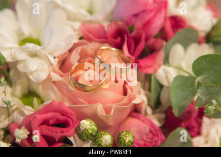 Wedding Rings on the natural roses bouquet Stock Photo