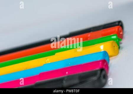 Set of multi-colored pens, tools for writing drawing, isolated on white. Stock Photo