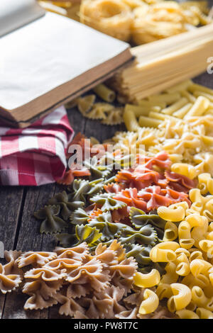 Various types of italian pasta on old wooden table. Stock Photo