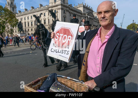 London, UK. 13th October 2018. Donnachadh McCarthy of Stop Killing Cyclists at the head of the funeral procession of cyclists behind a horse-drawn hearse to highlight the failure of governments from all the major parties to take comprehensive action on safer cycling. Stop Killing Cyclists call for £3 billion a year to be invested in a national protected cycling network and for urgent action to reduce the toxic air pollution from diesel and petrol vehicles which kills tens of thousands of people every year, and disables hundreds of thousands. The several hundred protesters staged a ten-minute d Stock Photo