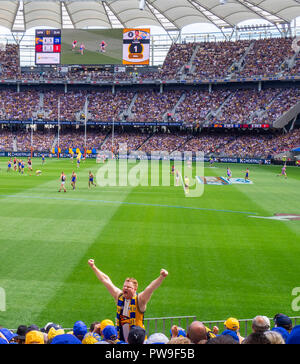 West Coast Eagles Football Club member fan and supporter with arms in the air at Optus Stadium 2018 AFL Preliminary Final Perth Western Australia. Stock Photo