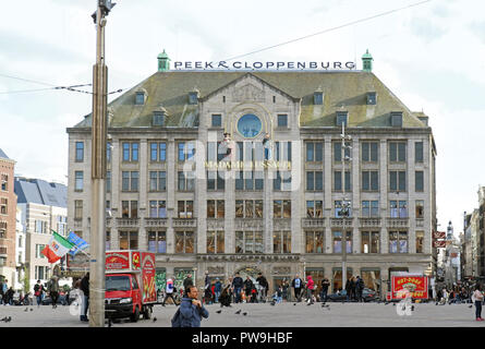 Busy Dam square with many people walking around and buying fast food in Amsterdam with sign for Madame Tussaud wax museum major tourist attraction Stock Photo