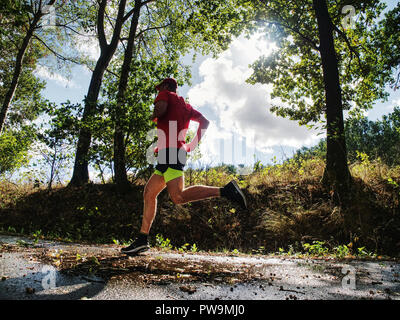 Recreation run during a sports activities in the open air forest. Summer running workout in health care and competition concept Stock Photo