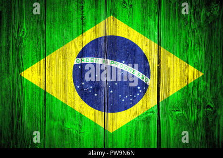 Brazil national flag over grungy wood wall board with the traditional green, yellow and blue colors. Concept image for Brazil and the Brazilian Portug Stock Photo