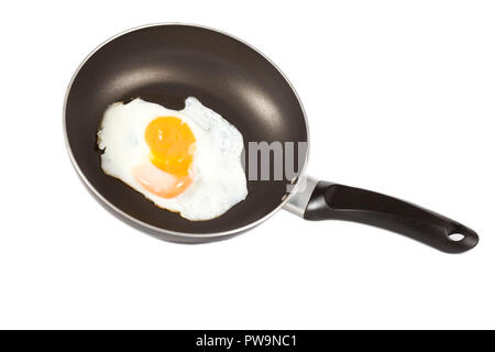 fried egg with broken yolk in frying pan Stock Photo