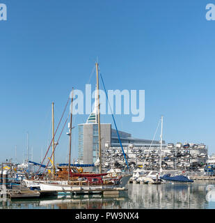 Liesure boats alongside The Camber area on Portsmouth Harbour, England, UK Spinnacker tower background. Stock Photo