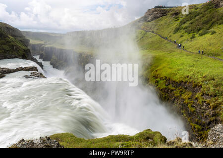 Tourist visiting Gullfoss, 'Golden Falls', a waterfall located in the canyon of the Hvítá river in southwest Iceland. Stock Photo