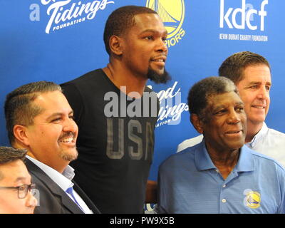 Oakland city councilmember Abel Guille, Golden State Warriors Finals MVP Kevin Durant, Warriors coach Al Attles and Good Tidings Foundation founder Larry Harper appear at an event to unveil four new basketball courts donated to the Lincoln Square Recreation Center in Oakland's Chinatown by the Kevin Durant Charity Foundation on May 17, 2017. Stock Photo