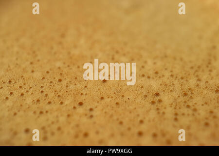 Texture of the just brewed coffee foam of aromatic Italian Espresso, selective focus and blurred background Stock Photo