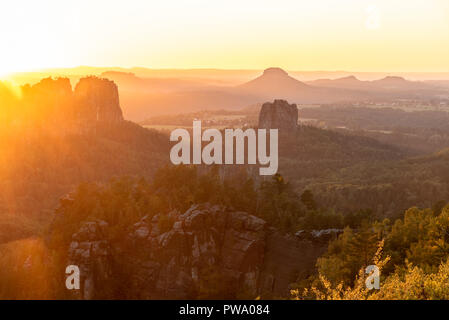 view over rock formations 'Schrammstone and Lilienstein' while the sun is setting, located in the Elbe Sandstone National park – the Saxon Switzerland Stock Photo