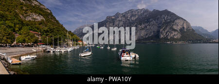 Boats at Valmedrera harbour on Lake Como, Italy, with mountains Stock Photo